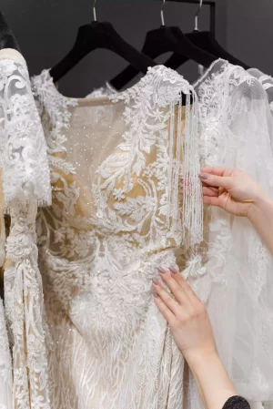 bride-examining-luxurious-white-cream-wedding-dres-2026-01-18-13-24-18-utc